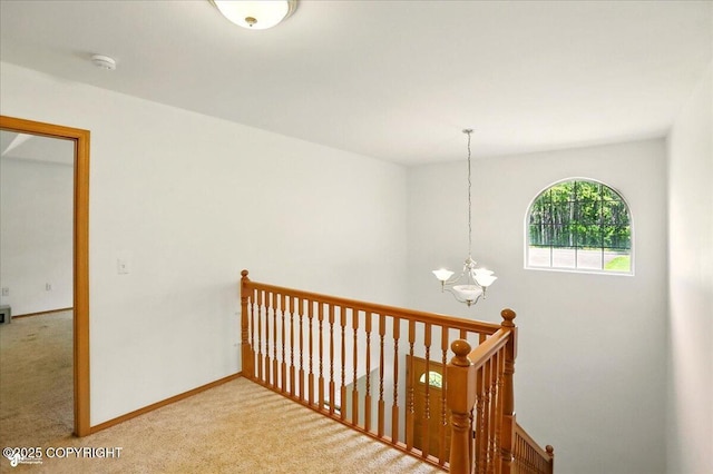 22030 Birch Creek Dr, Chugiak, AK 99567 - corridor with a chandelier, carpet flooring, an upstairs landing, and baseboards