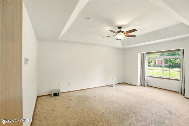 22030 Birch Creek Dr, Chugiak, AK 99567 - empty room with light colored carpet, a raised ceiling, a ceiling fan, and baseboards