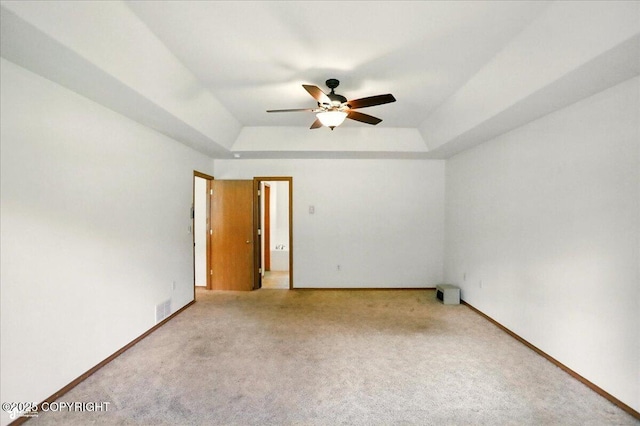22030 Birch Creek Dr, Chugiak, AK 99567 - carpeted empty room with a tray ceiling, a ceiling fan, and baseboards