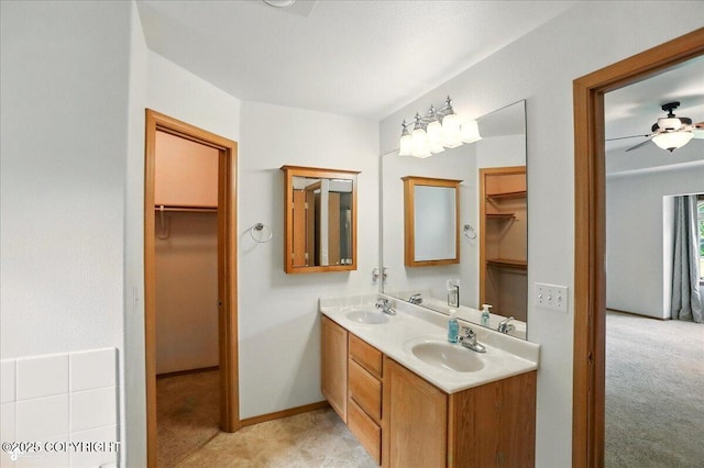 22030 Birch Creek Dr, Chugiak, AK 99567 - bathroom with double vanity, a walk in closet, and ceiling fan