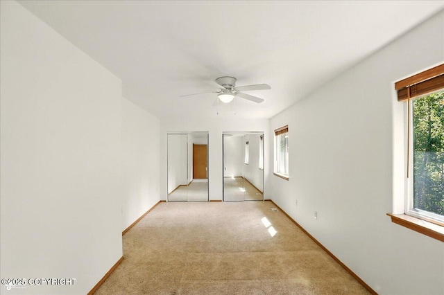 22030 Birch Creek Dr, Chugiak, AK 99567 - spare room featuring a ceiling fan, light carpet, and baseboards