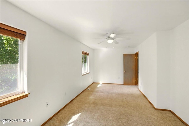 22030 Birch Creek Dr, Chugiak, AK 99567 - spare room with light colored carpet, a ceiling fan, and baseboards
