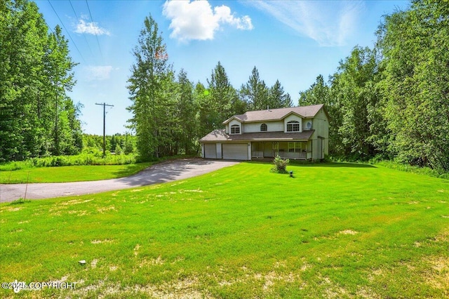 22030 Birch Creek Dr, Chugiak, AK 99567 - view of front of home featuring driveway, an attached garage, and a front lawn