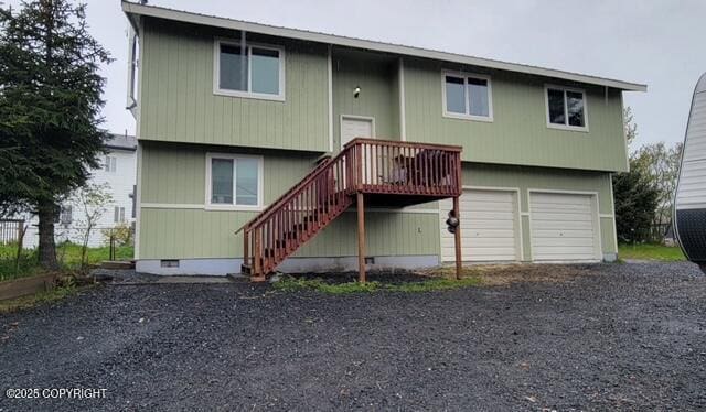 301 Teal Way, Kodiak, AK 99615 - rear view of property with gravel driveway, stairway, a garage, and a wooden deck