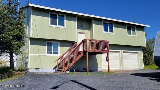 301 Teal Way, Kodiak, AK 99615 - rear view of property featuring a garage, stairs, and driveway