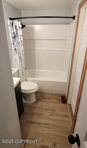 301 Teal Way, Kodiak, AK 99615 - bathroom with wood finished floors, vanity, shower / bath combo with shower curtain, and toilet