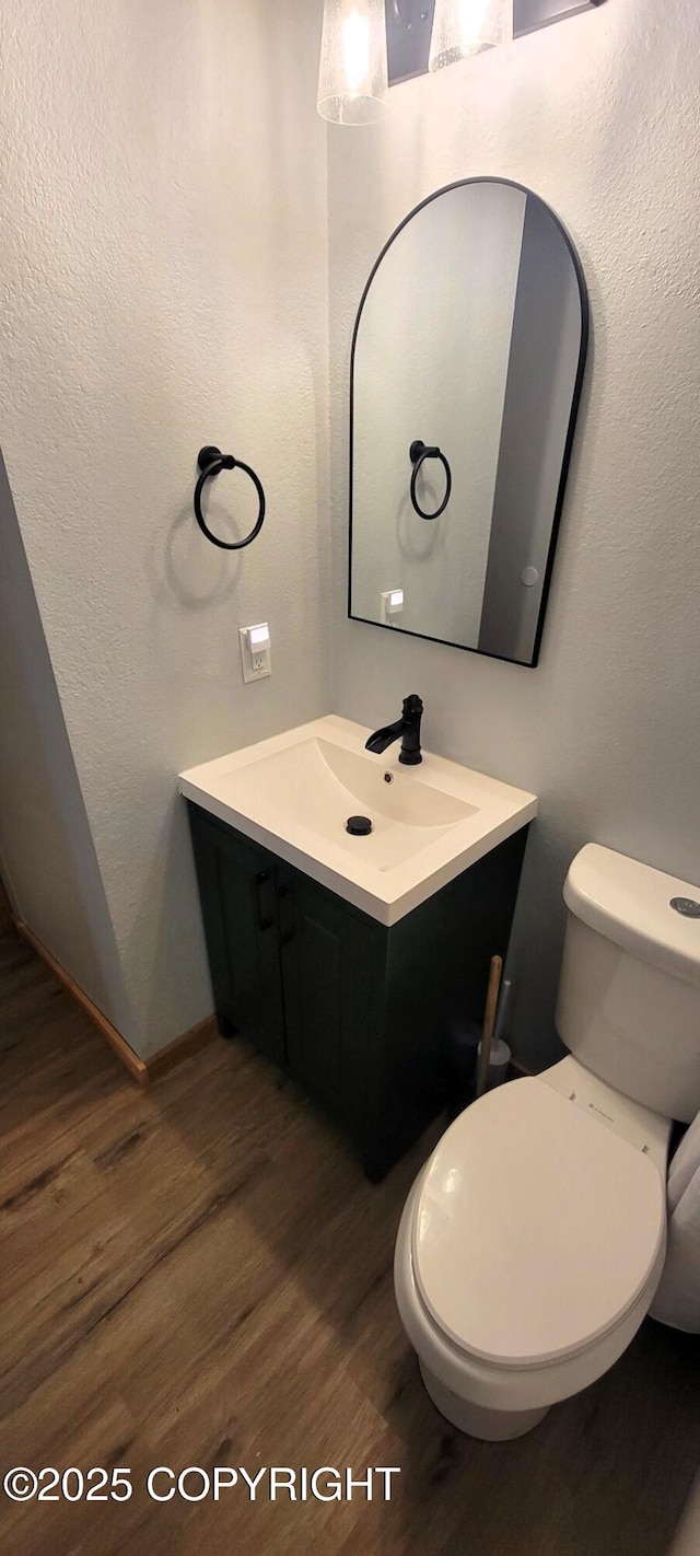 301 Teal Way, Kodiak, AK 99615 - bathroom featuring wood finished floors, vanity, toilet, and baseboards