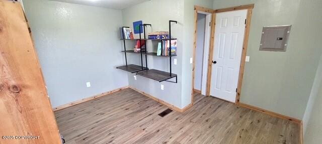 301 Teal Way, Kodiak, AK 99615 - empty room with wood finished floors, baseboards, and electric panel