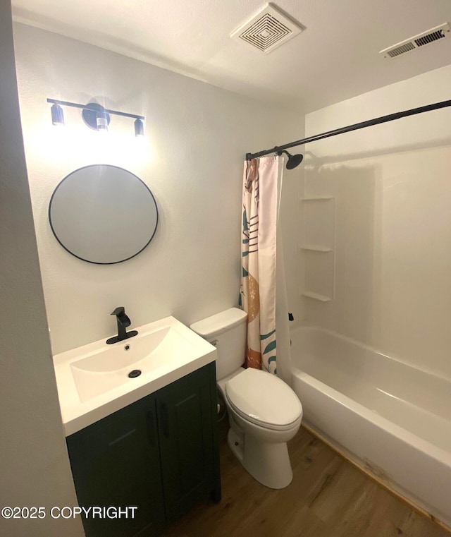 301 Teal Way, Kodiak, AK 99615 - bathroom featuring wood finished floors, toilet, vanity, and shower / bathtub combination with curtain