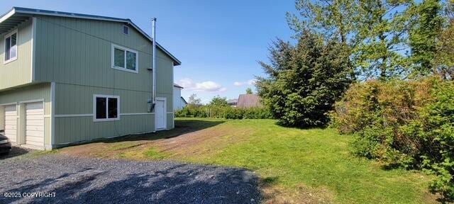 301 Teal Way, Kodiak, AK 99615 - view of home's exterior featuring a garage and a lawn