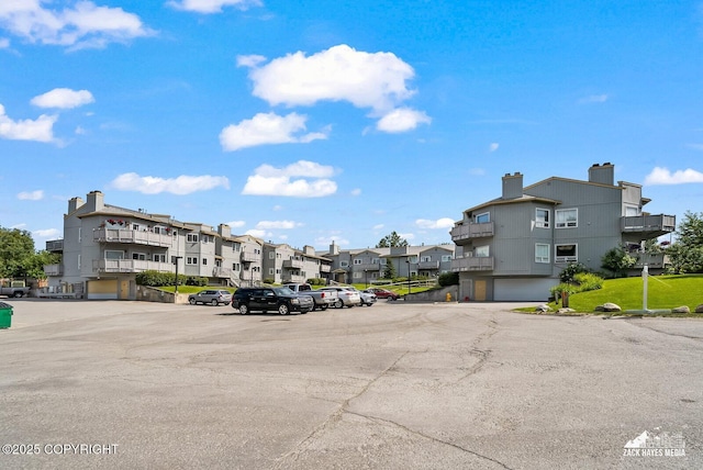 4109 Lynn Dr # 121, Anchorage, AK 99508 - uncovered parking lot featuring a residential view