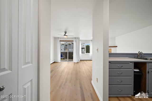 4109 Lynn Dr # 121, Anchorage, AK 99508 - hallway featuring light wood-type flooring and a baseboard radiator