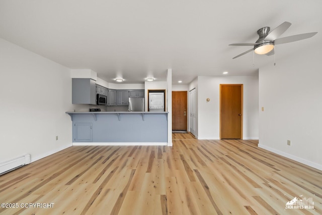 4109 Lynn Dr # 121, Anchorage, AK 99508 - unfurnished living room with ceiling fan, light wood-type flooring, recessed lighting, and baseboard heating