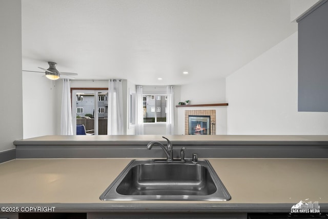 4109 Lynn Dr # 121, Anchorage, AK 99508 - kitchen with a fireplace, ceiling fan, and recessed lighting