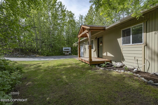 9845 E Lee Ann Dr, Palmer, AK 99645 - view of green lawn with asphalt driveway and a garage