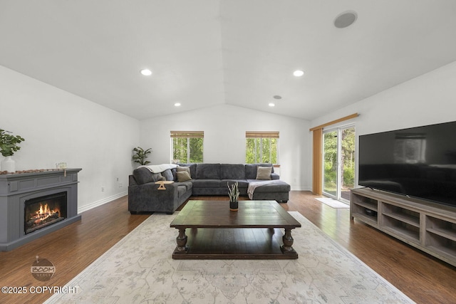9845 E Lee Ann Dr, Palmer, AK 99645 - living area with lofted ceiling, a glass covered fireplace, wood finished floors, recessed lighting, and baseboards