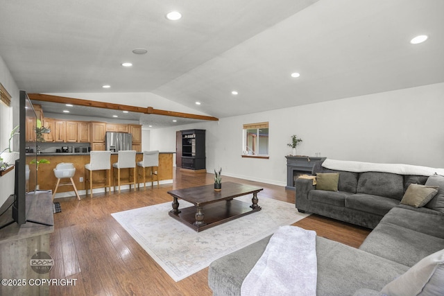 9845 E Lee Ann Dr, Palmer, AK 99645 - living area with vaulted ceiling, wood finished floors, recessed lighting, baseboards, and a lit fireplace