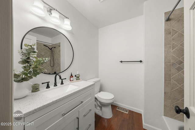 9845 E Lee Ann Dr, Palmer, AK 99645 - bathroom with vanity, wood finished floors, toilet, baseboards, and shower / washtub combination