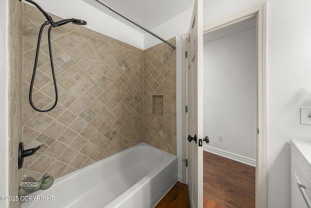 9845 E Lee Ann Dr, Palmer, AK 99645 - bathroom featuring shower / washtub combination, wood finished floors, vanity, and baseboards
