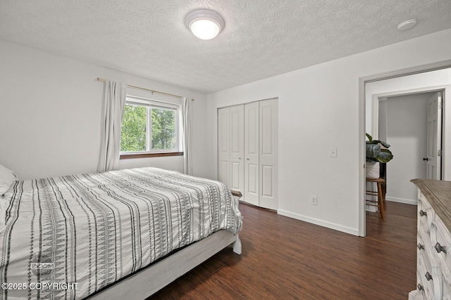 9845 E Lee Ann Dr, Palmer, AK 99645 - bedroom featuring dark wood-type flooring, a closet, a textured ceiling, and baseboards