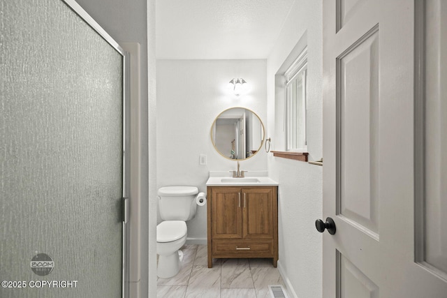 9845 E Lee Ann Dr, Palmer, AK 99645 - full bath featuring a shower stall, marble look tiles, vanity, toilet, and baseboards