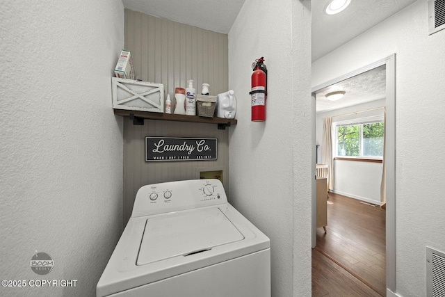 9845 E Lee Ann Dr, Palmer, AK 99645 - washroom featuring washer / dryer, wood finished floors, and a textured wall