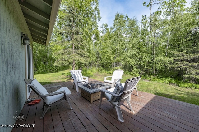 9845 E Lee Ann Dr, Palmer, AK 99645 - wooden terrace featuring an outdoor fire pit, a wooded view, and a lawn