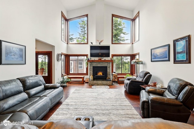 34952 Treeline Ave, Soldotna, AK 99669 - living area with a towering ceiling, a lit fireplace, and dark wood-style floors