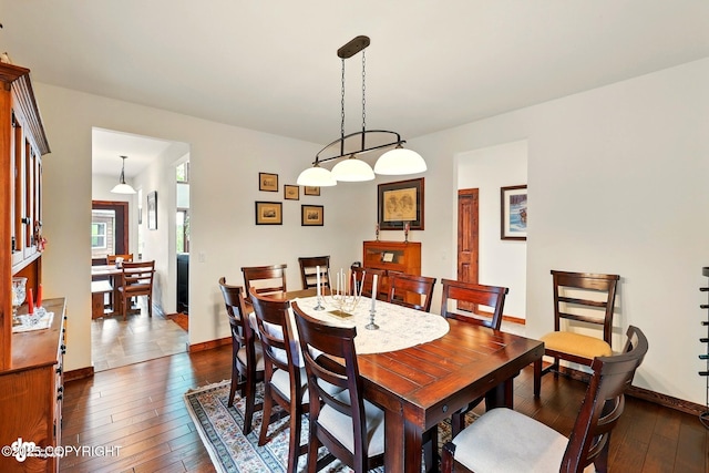 34952 Treeline Ave, Soldotna, AK 99669 - dining space with dark wood-style flooring and baseboards