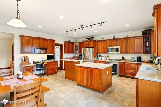 34952 Treeline Ave, Soldotna, AK 99669 - kitchen featuring appliances with stainless steel finishes, a center island, light countertops, brown cabinetry, and recessed lighting