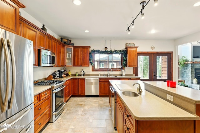 34952 Treeline Ave, Soldotna, AK 99669 - kitchen with appliances with stainless steel finishes, light countertops, a kitchen island with sink, recessed lighting, and french doors