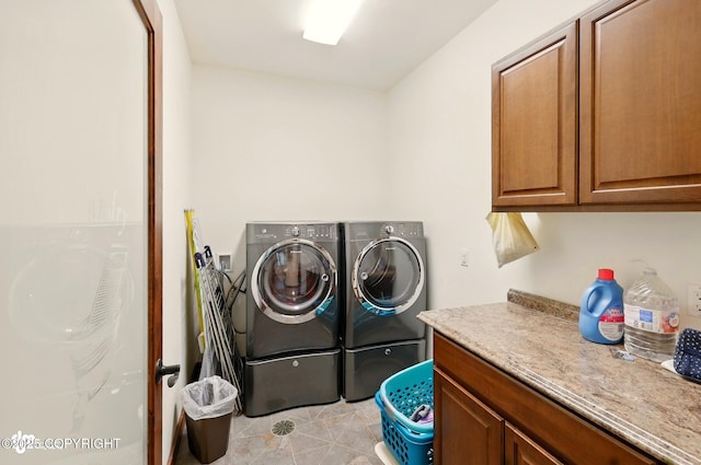 34952 Treeline Ave, Soldotna, AK 99669 - laundry room with cabinet space, washer and clothes dryer, and light tile patterned floors