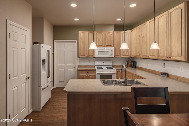 9650 E Forest Grove Cir # 10B, Palmer, AK 99645 - kitchen with white appliances, a sink, decorative backsplash, a peninsula, and dark wood finished floors