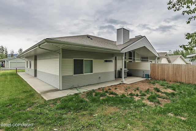 9650 E Forest Grove Cir # 10B, Palmer, AK 99645 - rear view of house featuring a patio, a chimney, and a shingled roof