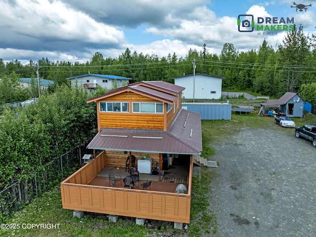 3745 W Machen Rd, Wasilla, AK 99623 - back of property featuring faux log siding and a wooden deck