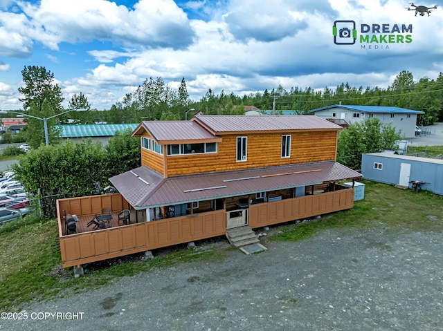 3745 W Machen Rd, Wasilla, AK 99623 - rear view of house featuring a metal roof and view of scattered trees