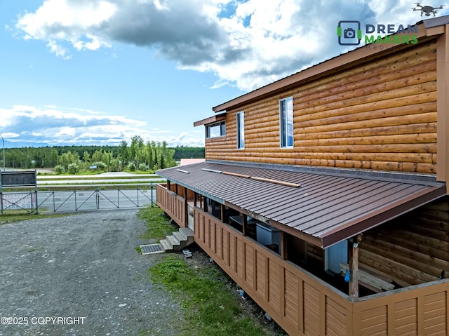 3745 W Machen Rd, Wasilla, AK 99623 - view of home's exterior featuring faux log siding and an exterior structure