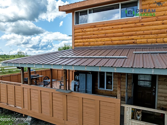3745 W Machen Rd, Wasilla, AK 99623 - rear view of house featuring log veneer siding and a metal roof