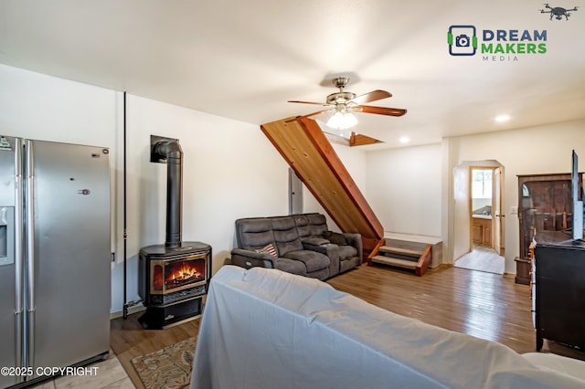 3745 W Machen Rd, Wasilla, AK 99623 - living area with a wood stove, a ceiling fan, wood finished floors, and arched walkways