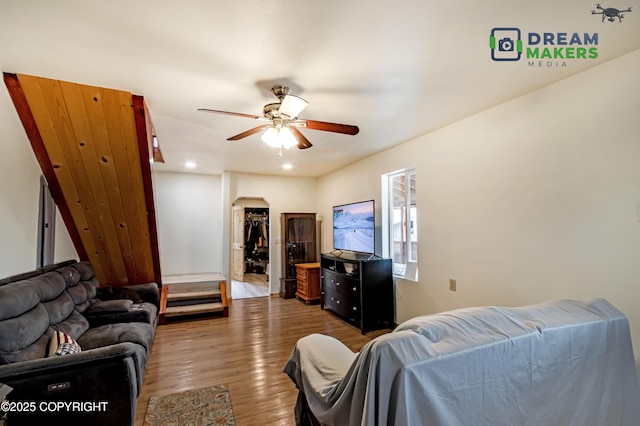 3745 W Machen Rd, Wasilla, AK 99623 - living area with arched walkways, wood finished floors, a ceiling fan, and recessed lighting