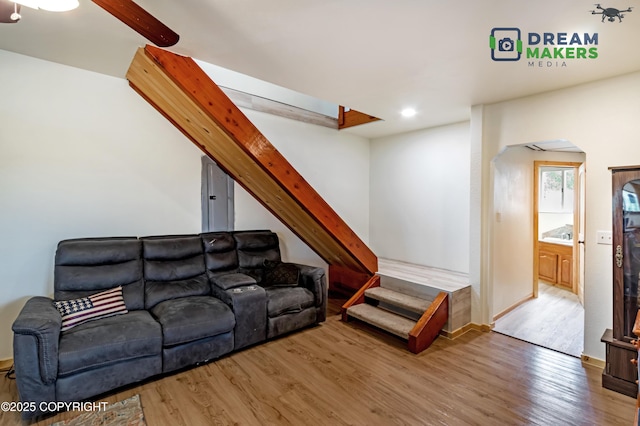 3745 W Machen Rd, Wasilla, AK 99623 - living room featuring arched walkways, wood finished floors, stairs, and recessed lighting