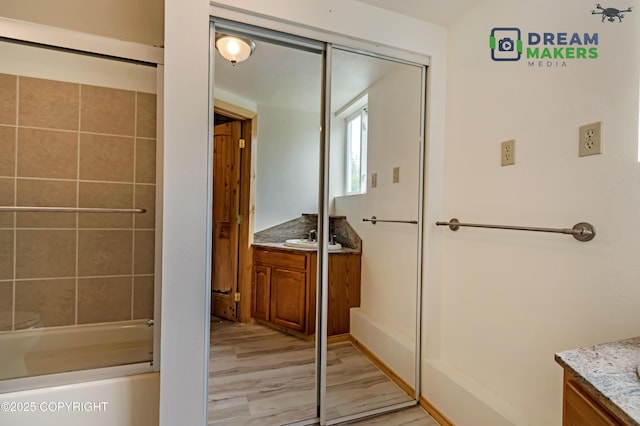 3745 W Machen Rd, Wasilla, AK 99623 - full bathroom featuring vanity, wood finished floors, and shower / bathtub combination