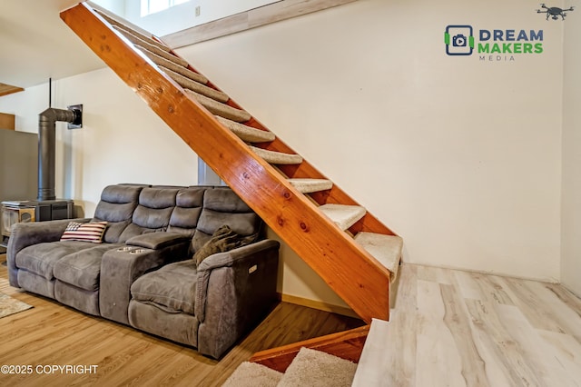 3745 W Machen Rd, Wasilla, AK 99623 - living room featuring stairs, wood finished floors, and a wood stove