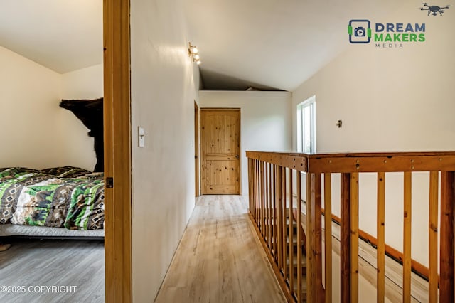 3745 W Machen Rd, Wasilla, AK 99623 - hallway with vaulted ceiling, wood finished floors, and an upstairs landing