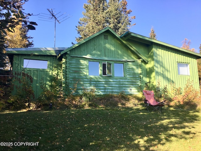 4075 Mattox Rd, Homer, AK 99603 - view of side of home with log exterior, a yard, and board and batten siding