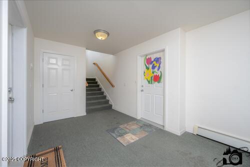 500 W Roy Rd, Wasilla, AK 99654 - carpeted entrance foyer with stairway and baseboard heating