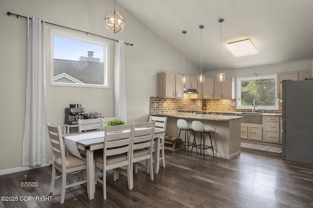 19113 Sarichef Loop, Eagle River, AK 99577 - dining area featuring dark wood-style floors, vaulted ceiling, and a chandelier