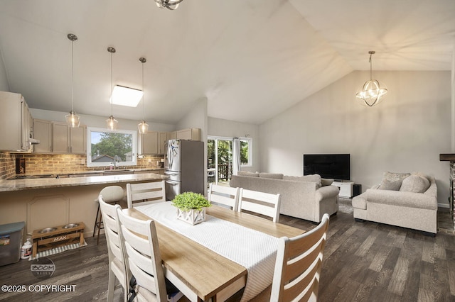 19113 Sarichef Loop, Eagle River, AK 99577 - dining space with dark wood finished floors, vaulted ceiling, plenty of natural light, and a chandelier