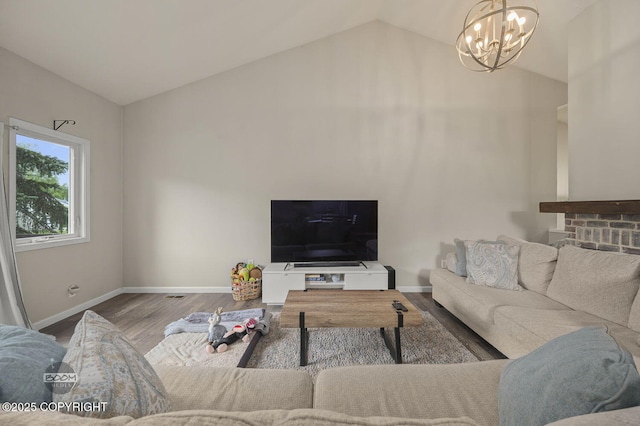19113 Sarichef Loop, Eagle River, AK 99577 - living room with lofted ceiling, a chandelier, baseboards, and wood finished floors