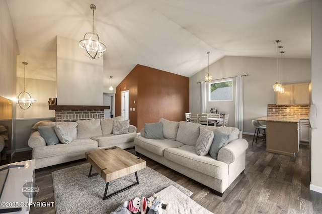 19113 Sarichef Loop, Eagle River, AK 99577 - living area featuring dark wood-style flooring, a chandelier, vaulted ceiling, and baseboards